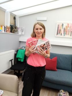 The centre manager with a few of the books donated The centre manager with a few of the books donated